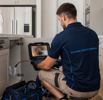 Clearing a blocked sink at a Woolloomooloo property